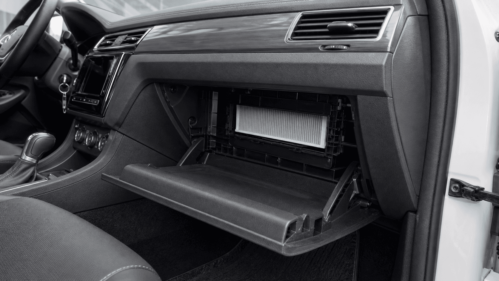 Open glove box showing the cabin filter access area